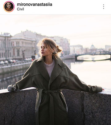 autumn photo ideas for instagram - a girl on a bridge in a coat